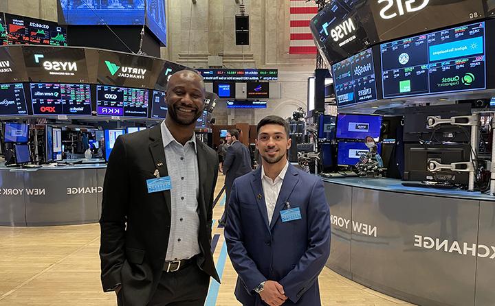 23岁的瑞安 里维拉(左)和Dr. 基督教Nsiah(右)在纽约证券交易所的地板上.